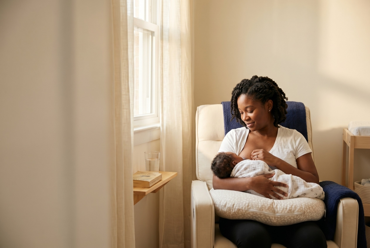 New mother breastfeeding her infant in a calm home setting